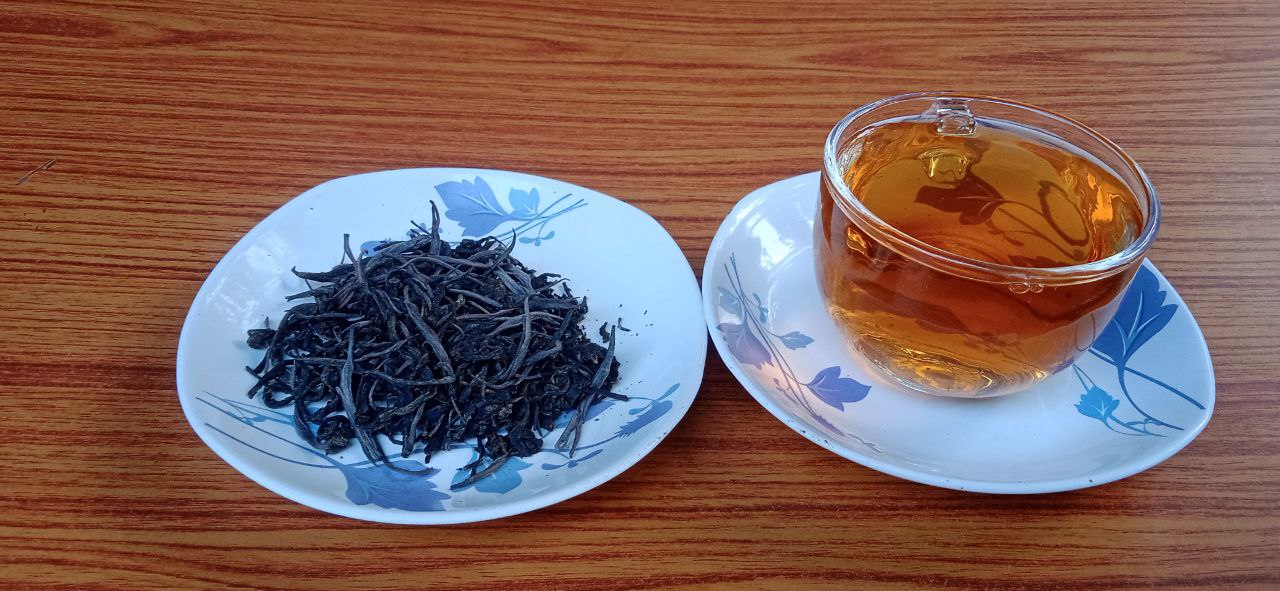 A Cup of Tea and a Plate of Black Orthodox Tea Leaves